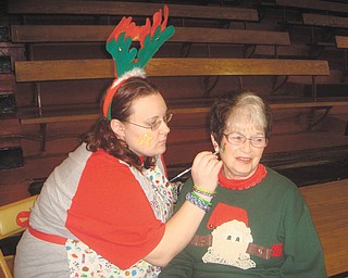 Girard Junior Women raise funds: Girard Junior Women member Kendra Allen, left, paints the face of Colette Chuey, also a member, at a recent fundraiser. The group will meet at 6:30 p.m. today at Amen Corner, 20 W. Main St., Girard. The program will feature a discussion of the benefits of the recent partnership between the Girard Free Library and Clevnet, a multimember library consortium that spans 10 counties in Northeast Ohio. Heather Walker will present the program, and Roselyn Gadd of GJW will host the meeting. Guests are welcome and can order from the menu.