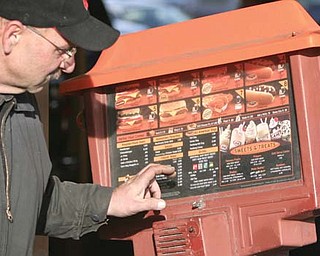Tony Torisk of Struthers checks out the outdoor menu board.