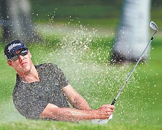 Graham DeLaet of Canada blasts out of a bunker on the 13th hole during the first round of the Sony Open golf tournament Thursday at Waialae Country Club in Honolulu, Hawaii. DeLaet shot a 7-under-63 to claim the top spot on the leaderboard.