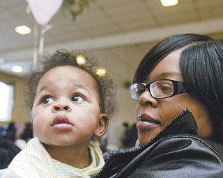Kayden Smith, 6 months, takes in the scene during the sixth annual citywide baby shower on Monday at the McGuffey Centre. He was with his aunt, Kelley Ray of Youngstown.