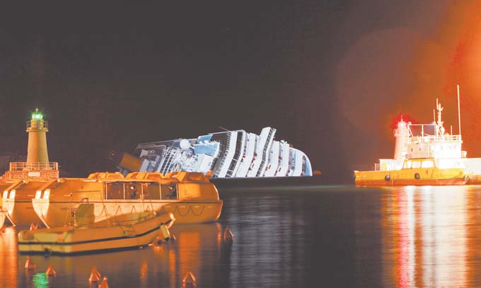 The cruise ship Costa Concordia leans on its side Monday after running aground near the tiny Tuscan island of Giglio, Italy, last Friday. The rescue operation was called off midafternoon Monday after the Costa Concordia shifted a few inches in rough seas. The fear is that if the ship shifts significantly, some 500,000 gallons of fuel may begin to leak.
