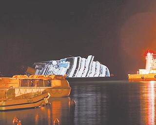 The cruise ship Costa Concordia leans on its side Monday after running aground near the tiny Tuscan island of Giglio, Italy, last Friday. The rescue operation was called off midafternoon Monday after the Costa Concordia shifted a few inches in rough seas. The fear is that if the ship shifts significantly, some 500,000 gallons of fuel may begin to leak.