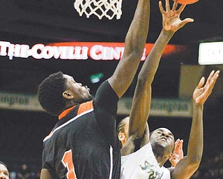 Ursuline’s Kevin Jackson (30) has a shot blocked by Sharon’s Marlin Sanders (1) in the third period of their basketball game during the See Them Rise Classic on Monday at the Covelli Centre in Youngstown. The Irish edged the Tigers, 57-55.