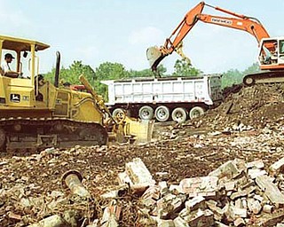 Workers from D&A Excavating of Canfield remove debris from the site of the former Ohio Leather Co. along North State Street in Girard. Although the demolition took place more than 10 years ago, the site of the once-sprawling leather factory remains contaminated. Above, the plant is pictured in its heyday in the 1940s.
