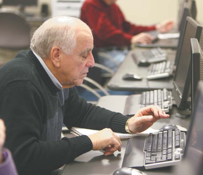 Auggie Ruggiero of Austintown checks out some websites during a computer class at the Austintown Senior Center. The class meets weekly and is taught by volunteers from the Austintown Local School District. Barb Kliner, district grant coordinator, met with seniors Tuesday to discuss helpful websites such as AARP.com, RetailMeNot.com and Amazon.com.