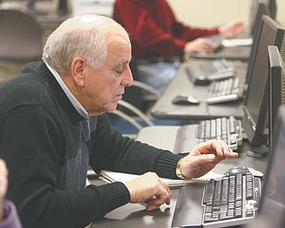 Auggie Ruggiero of Austintown checks out some websites during a computer class at the Austintown Senior Center. The class meets weekly and is taught by volunteers from the Austintown Local School District. Barb Kliner, district grant coordinator, met with seniors Tuesday to discuss helpful websites such as AARP.com, RetailMeNot.com and Amazon.com.