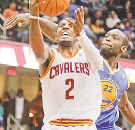 Cleveland Cavaliers’ Kyrie Irving (2) shoots in front Golden State Warriors’ Charles Jenkins in the second quarter of a game Tuesday in Cleveland.