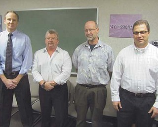 Ronald Catchpole of Howland, third from left, stands with the three men honored Wednesday by the Ohio State Highway Patrol for their actions Oct. 29, when Catchpole’s 1990 Pietenpol Aircamper crashed just after takeoff from Price Field on Pleasant Valley Road in Vienna Township. From left are Dr. Bob Bennett, Bob Boyd, Catchpole and Jeff Jardine.