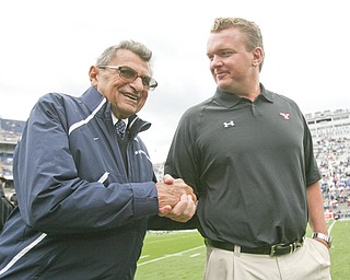 ROBERT K. YOSAY | THE VINDICATOR..YSU Coach Eric Wolford and PSU Coach Joe Paterno share a moment before their game at Beaver Stadium in Happy Valley.
