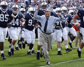 Penn State coach Joe Paterno leads his team onto the field before the game against Akron on Saturday, Sept. 4, 2004, in State College, Pa. Penn State won 48-10. (AP Photo /Carolyn Kaster)