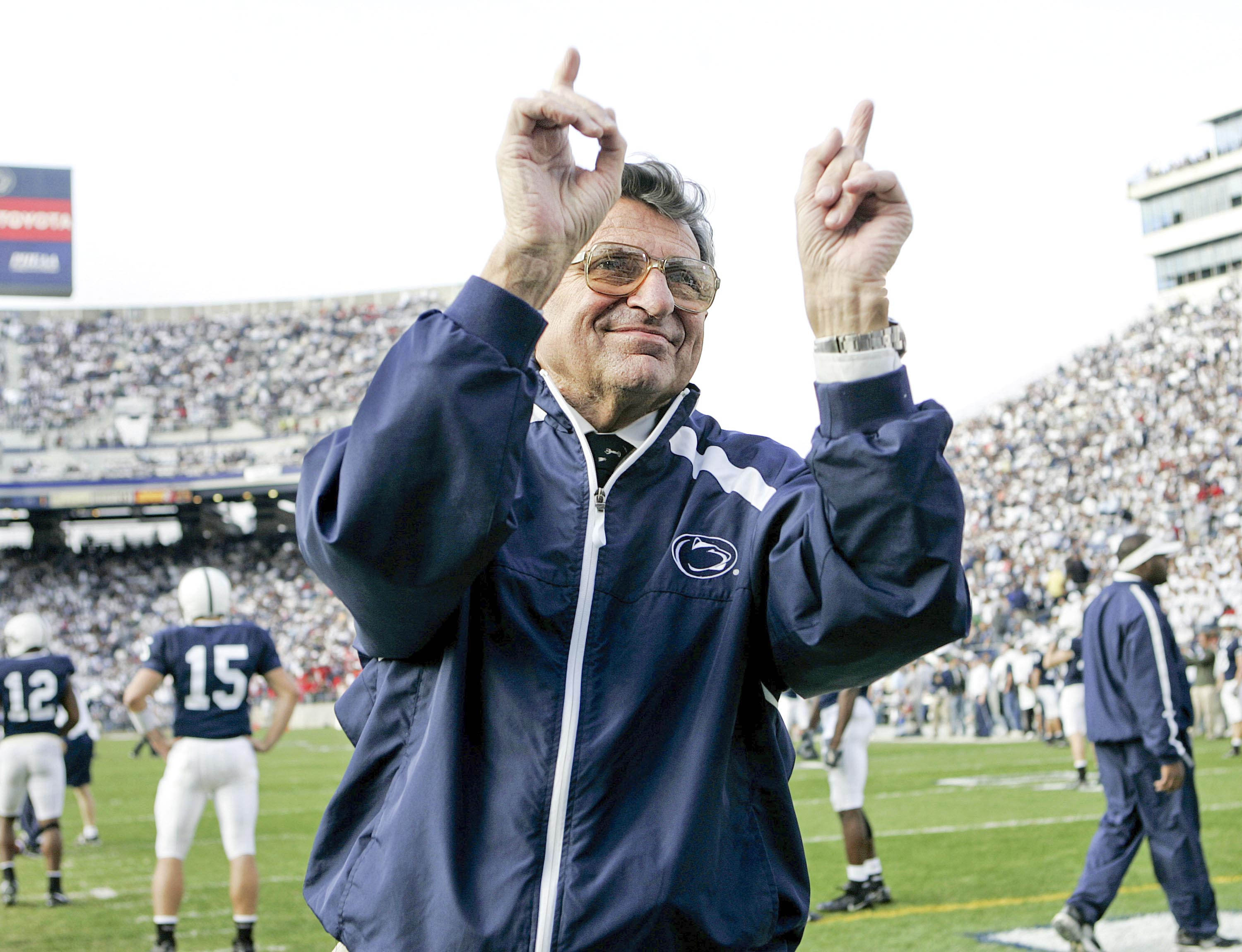 In this file photo from Nov. 5, 2005,  Penn State football coach Joe Paterno acknowledges the crowd during warm-ups before the NCAA college football game against Wisconsin in State College, Pa.  Paterno, the longtime Penn State coach who won more games than anyone else in major college football but was fired amid a child sex abuse scandal that scarred his reputation for winning with integrity, died Sunday, Jan. 22, 2012. He was 85.  (AP Photo/Carolyn Kaster, File)