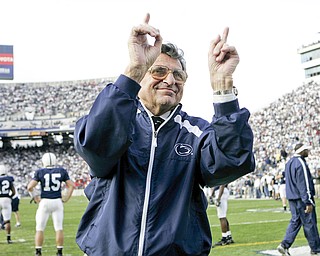 In this file photo from Nov. 5, 2005, Penn State football coach Joe Paterno acknowledges the crowd during warm-ups before the NCAA college football game against Wisconsin in State College, Pa. Paterno, the longtime Penn State coach who won more games than anyone else in major college football but was fired amid a child sex abuse scandal that scarred his reputation for winning with integrity, died Sunday, Jan. 22, 2012. He was 85. (AP Photo/Carolyn Kaster, File)