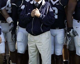 Penn State football coach Joe Paterno stands with his team before they take the field for a football game against Wisconsin in State College, Pa., in this Oct. 13, 2007, file photo. Penn State won 38-7. Paterno is being paid about a half-million dollars a year, state officials said Thursday, Nov. 29, 2007, ending one of the most closely guarded secrets of college sports in Pennsylvania. (AP Photo/Carolyn Kaster)