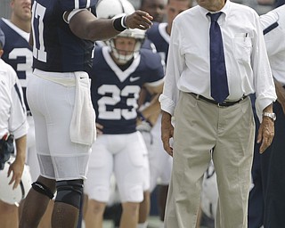 Penn State head coach Joe Paterno, right, quarterback Daryll Clark talk on the sideline during the first half of their college football game against Coastal Carolina Saturday, Aug. 30, 2008 at Beaver Stadium in State College, Pa. The scoreboard showed a smashing success for Penn State's offense, but quarterbacks coach Jay Paterno sought to temper some of the enthusiasm following the season-opening, 66-10 blowout. (AP Photo/Carolyn Kaster)