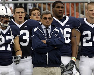 In this Sept. 6, 2008 file photo, Penn State head coach Joe Paterno, center, stands with players, from left, Jacob Fragnano, Chris Colasanti, Mark Wedderburn, and J.D. Mason as they watch the game for the sideline during the first half of their NCAA college football game against Oregon State at Beaver Stadium in State College, Pa. After skating through its nonconference schedule, No. 12 Penn State could gain some respect with a win Saturday night in its Big Ten opener against No. 22 Illinois. (AP Photo/Carolyn Kaster, File)