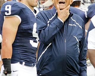 Penn State coach Joe Paterno, right, stands on the sidelines during the fourth quarter of an NCAA college football game against Youngstown State in State College, Pa., Saturday, Sept. 4, 2010. Penn State won 44-14. At left is running back Michael Zordich (9). (AP Photo/Gene J. Puskar)