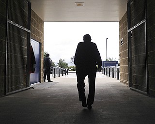 In this Oct. 5, 2010 file photo, Penn State football coach Joe Paterno leaves Beaver Stadium after his weekly NCAA college football news conference on Tuesday, Oct. 5, 2010 in State College, Pa. Paterno, the longtime Penn State coach who won more games than anyone else in major college football but was fired amid a child sex abuse scandal that scarred his reputation for winning with integrity, died Sunday, Jan. 22, 2012. He was 85. (AP Photo/Pat Little, File)