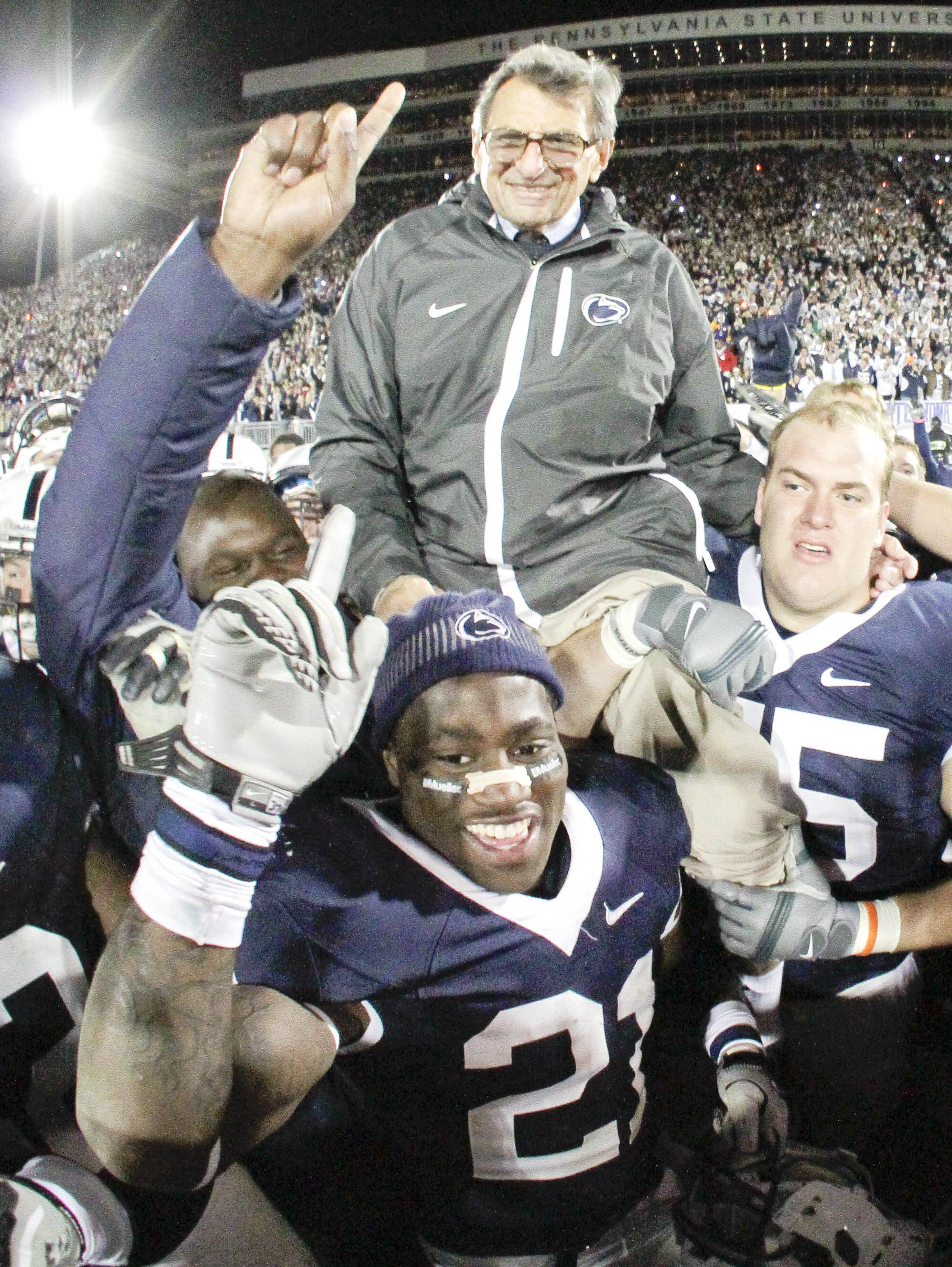Penn State coach Joe Paterno is carried off the field  by his players after getting his 400th collegiate win, defeating Northwestern 38-21 in an NCAA college football game in State College, Pa., Saturday, Nov.l  6, 2010.  (AP Photo/Gene J. Puskar)