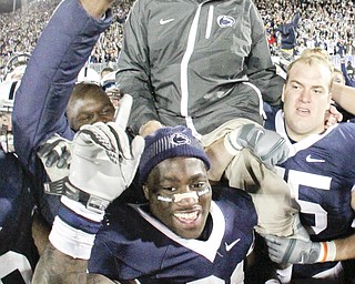 Penn State coach Joe Paterno is carried off the field by his players after getting his 400th collegiate win, defeating Northwestern 38-21 in an NCAA college football game in State College, Pa., Saturday, Nov.l 6, 2010. (AP Photo/Gene J. Puskar)