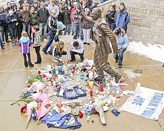 Penn State fans pay thier respects at a statue of Joe Paterno outside Beaver Stadium on the Penn State University campus after learning of his death Sunday, Jan. 22, 2012 in State College,Pa.. (AP Photo/Gene J. Puskar)