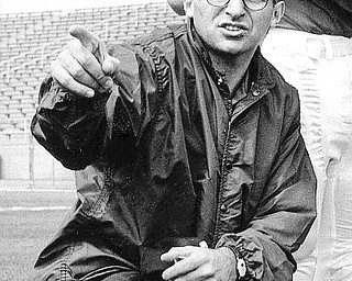Joe Paterno, associate football coach at Penn state, directs players, Jan. 28, 1965 at State College, Pa. (AP Photo)