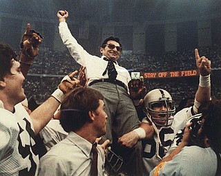 In this Jan. 1, 1983 file photo, Penn State football coach Joe Paterno celebrates as he is carried off the field after a 27-23 victory against Georgia in the Sugar Bowl, to claim the national championship, at the Superdome in New Orleans. Paterno say he plans to retire at the end of the season, his long and illustrious career brought down because he failed to do all he could about an allegation of child sex abuse against a former assistant. (AP Photo/File)