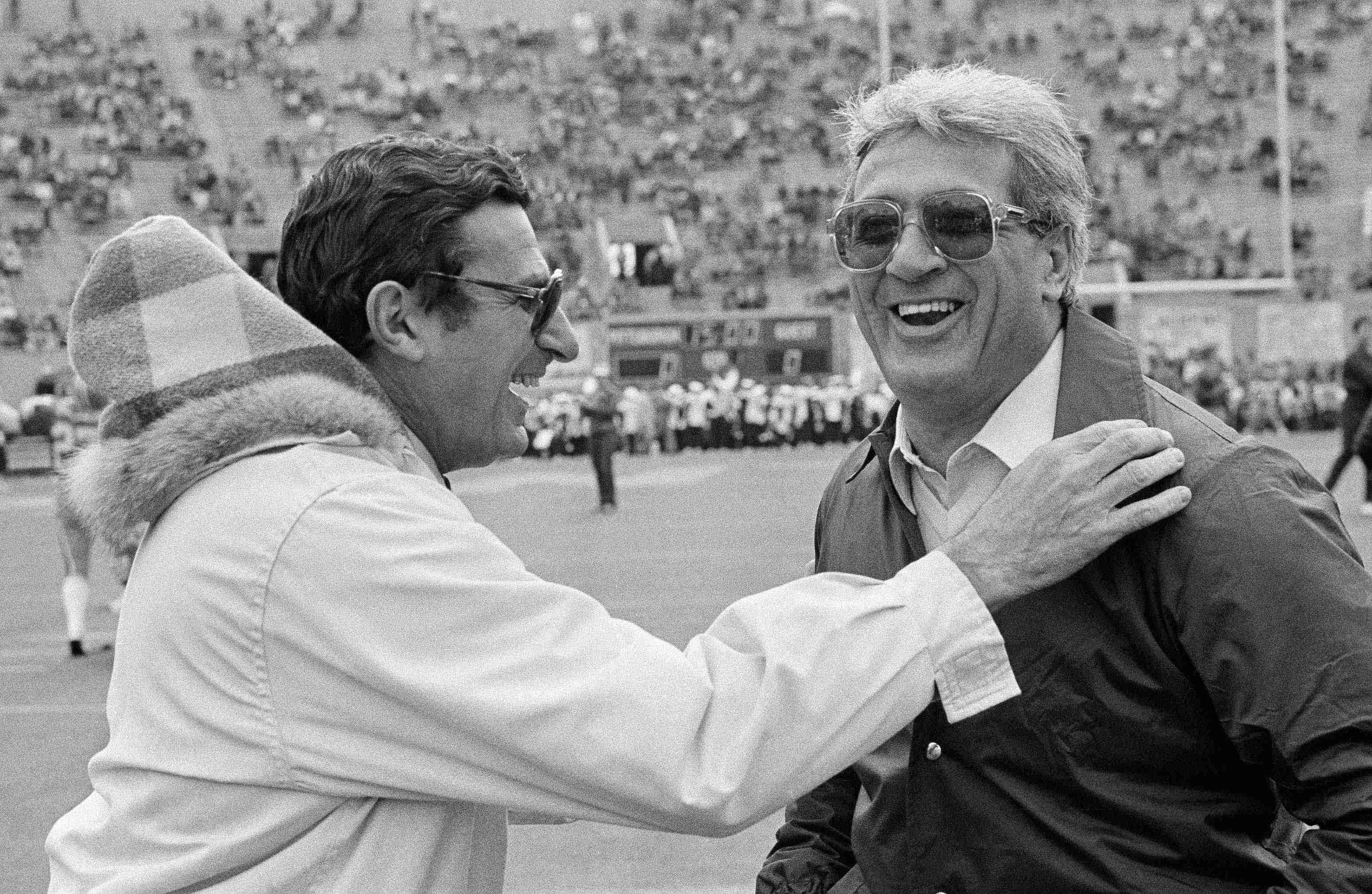 In this Nov. 19, 1983, file photo, Penn State coach, Joe Paterno, left, and Pittsburgh coach Foge Fazio talk before a college football game in Pittsburgh. Fazio, who succeeded Jackie Sherrill ascoach at alma mater Pittsburgh and later was a defensive coordinator for the NFL's Vikings and Browns, died Wednesday night, Dec. 2, 2009, following a lengthy battle with leukemia. He was 71. (AP Photo/Gene J. Puskar, File)