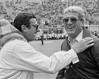 In this Nov. 19, 1983, file photo, Penn State coach, Joe Paterno, left, and Pittsburgh coach Foge Fazio talk before a college football game in Pittsburgh. Fazio, who succeeded Jackie Sherrill ascoach at alma mater Pittsburgh and later was a defensive coordinator for the NFL's Vikings and Browns, died Wednesday night, Dec. 2, 2009, following a lengthy battle with leukemia. He was 71. (AP Photo/Gene J. Puskar, File)