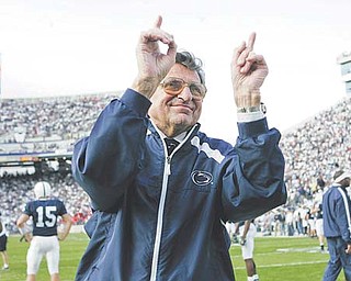 Penn State football coach Joe Paterno acknowledges the crowd during warm-ups before a game in State College, Pa. Paterno, who in his 62 years with the Nittany Lions won more games than any other major college coach, died Sunday. He was 85.