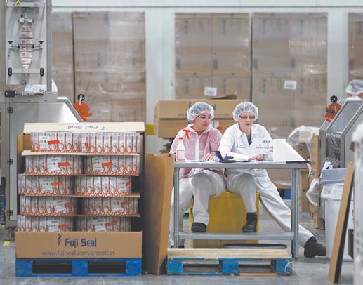 Two employees work in the sleeving plant where labels are put on containers at Chobani Greek Yogurt
in South Edmeston, N.Y. Greek yogurt accounts for a quarter of the total yogurt market after a dizzying
growth spurt.