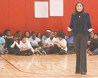 Rosalind Wiseman, an author and speaker, talks to sixth- and seventh-graders at Woodrow Wilson Middle School on Monday about bullying. Wiseman wrote the book “Queen Bees and Wannabes,” which became the inspiration for the movie “Mean Girls.”