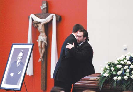 Michael Zordich, right, a former Cardinal Mooney standout, embraces fellow Penn State football player Kevin Blanchard as he replaces Blanchard as an honor guard in the Pasquerilla Spiritual Center on the Penn State campus for the viewing of former Penn State coach Joe Paterno on Tuesday in State College, Pa. Paterno died Sunday morning.