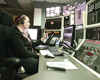 Boardman dispatcher Lauren Bruno, above, directs emergency calls to police and fire Wednesday. The process of hiring dispatchers has been bumped up from September 2012 to now.