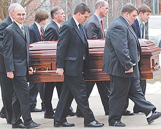 Pallbearers including sons Jay Paterno, foreground right, and Scott Paterno, foreground center, carry the coffin of former Penn State coach Joe Paterno after funeral services at the Pasquerilla Spiritual Center on the Penn State campus Wednesday in State College, Pa. Paterno, 85, died of lung cancer Sunday morning.