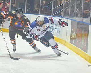 Youngstown Phantoms defenseman Chris Bradley (3) closes in on Team USA’s Tyler Motte during a recent game at the Covelli Centre. Bradley was selected last week’s USHL Defenseman of the Week.