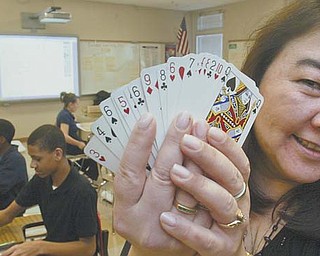Jane Haggerty, math coach at P. Ross Berry Eighth and Ninth Grade Academy in Youngstown, uses an ordinary deck of playing cards to help students improve their math skills. The playing cards were on her teacher wish list.