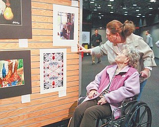 Lydia Cherep Becker, guidance counselor at Bristol High School, shows her mother, Mary Cherep, some of her students’ work at the Art Outreach Gallery in Eastwood Mall in Niles. Entries into the 2012 Northeastern Ohio Regional Scholastic Art Awards are on display.