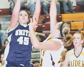 United’s Taylor Smith (45) shoots over South Range’s Kristin Robinson (24) while Kelsey Maynard watches
during Monday’s game at South Range High.