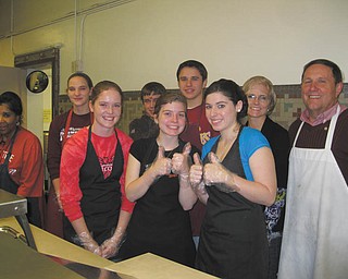 Students serve dinner to 100+: Serving an evening meal recently at the Rescue Mission of Mahoning Valley were Fitch High School Interact Club members: front row, left to right, Megan Miller, Alyssa Conn and Kirsty Thurston; and back row, left to right, Jaclynn Choma, Brandon Rivello, Zarek Bell, and advisers Tina Kubacki and Gary Reel. Standing at the far left is Carmella Harris, a cook at the Rescue Mission. The Interact Club is sponsored by the Rotary Club of Austintown and is open to all Fitch students.