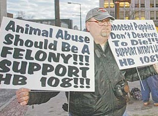 Mike Smeck, of Amherst, Ohio, was one of a small group who gathered Tuesday in downtown Youngstown to rally against the abuse of animals. Smeck and others held signs supporting House Bill 108, or Nitro’s Law, which would make animal abuse inside a kennel a felony offense.