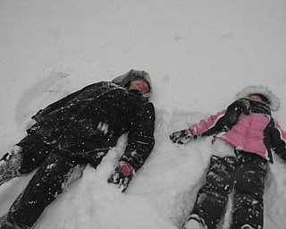 Mia Lazazzera, 5, of Canfield, makes snow angels with her grandma, Theresa Panezich, while visiting in Edinburg, Pa. Photo taken by Mia's mom, Mindy Lazazzera.