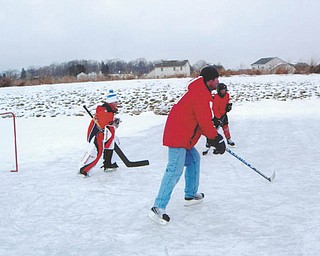 Goalie Trey Imhoff, and his dad, Bernie Imhoff, both of New Middletown, play pond hockey. Photo sent in by Mr. and Mrs. Bernard Imhoff of New Middletown.