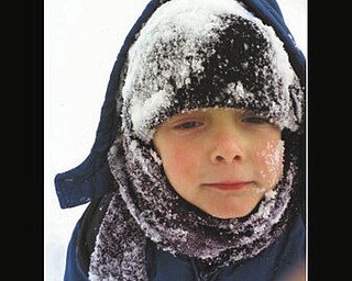Timmy Kerr of Poland has a blast playing in his first snow. Photo sent by Gary Kerr.