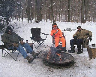 At the Boy Scouts' Klondike Derby at Camp Stambaugh, Dale Gottberg, left, Bobby Granchie and Scoutmaster Jeff Wormley of Troop 101 in Struthers take a break.