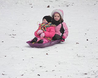 It"s the first time sled-riding for Mia, 5, and Carlie, 4, Lazazzera of Canfield. They were at the bike trail in Mill Creek Park. Photo taken by their mother, Mindy Lazazzera.