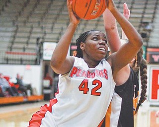 Youngstown State’s Brandi Brown (42) drives past Valparaiso’s Gina Lange (31) during the second half of
Thursday’s game at YSU’s Beeghly Center. Brown scored 20 points and grabbed 10 rebounds in the Penguins’
64-58 victory.