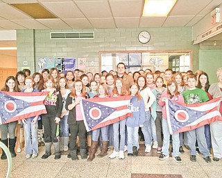 It’s a banner day! Columbiana County Recorder Craig Brown, in the middle, recently presented state of Ohio flags to social studies classes at Westgate Middle School in East Liverpool. Fifth- and sixth-graders welcomed him along with Mrs. Shari Voltz, at left, and Mrs. Vicky Pearson, far right.