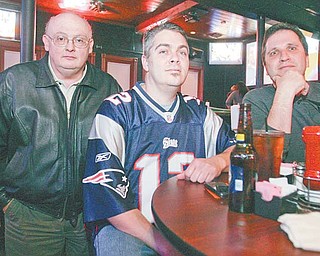 Lou DiNardo, left, Frank Tondo, wearing a Patriots jersey, and John Wojtkowiak, all of Boardman, watch the Super Bowl on Sunday at the Youngstown Sports Grille, a Boardman bar and restaurant.