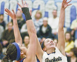Lowellville’s Kaye Solak (4) shoots against Western Reserve’s Linley Mamonis during the first half of Monday’s
Inter Tri-County League game. The Rockets clinched the league championship with a 74-50 victory.