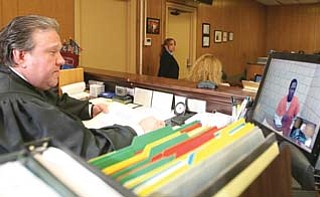 Youngstown Municipal Court Magistrate Anthony Sertick Jr. arraigns an inmate Monday, the first day for the new $22,000 video system.